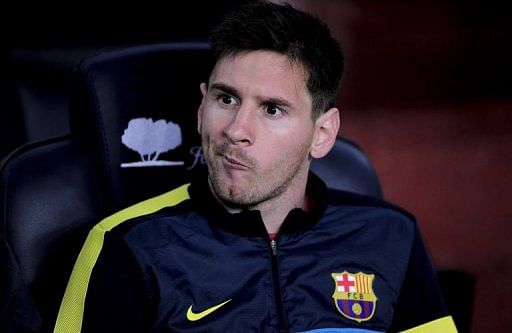 Barcelona's Lionel Messi grimaces as he sits on the bench at the Camp Nou stadium in Barcelona on May 5, 2013